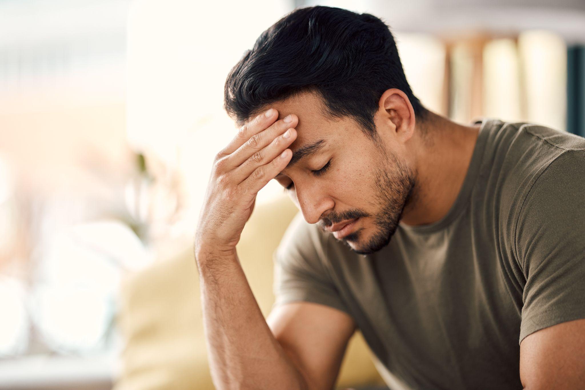 headache and stress of man in living room with mental health