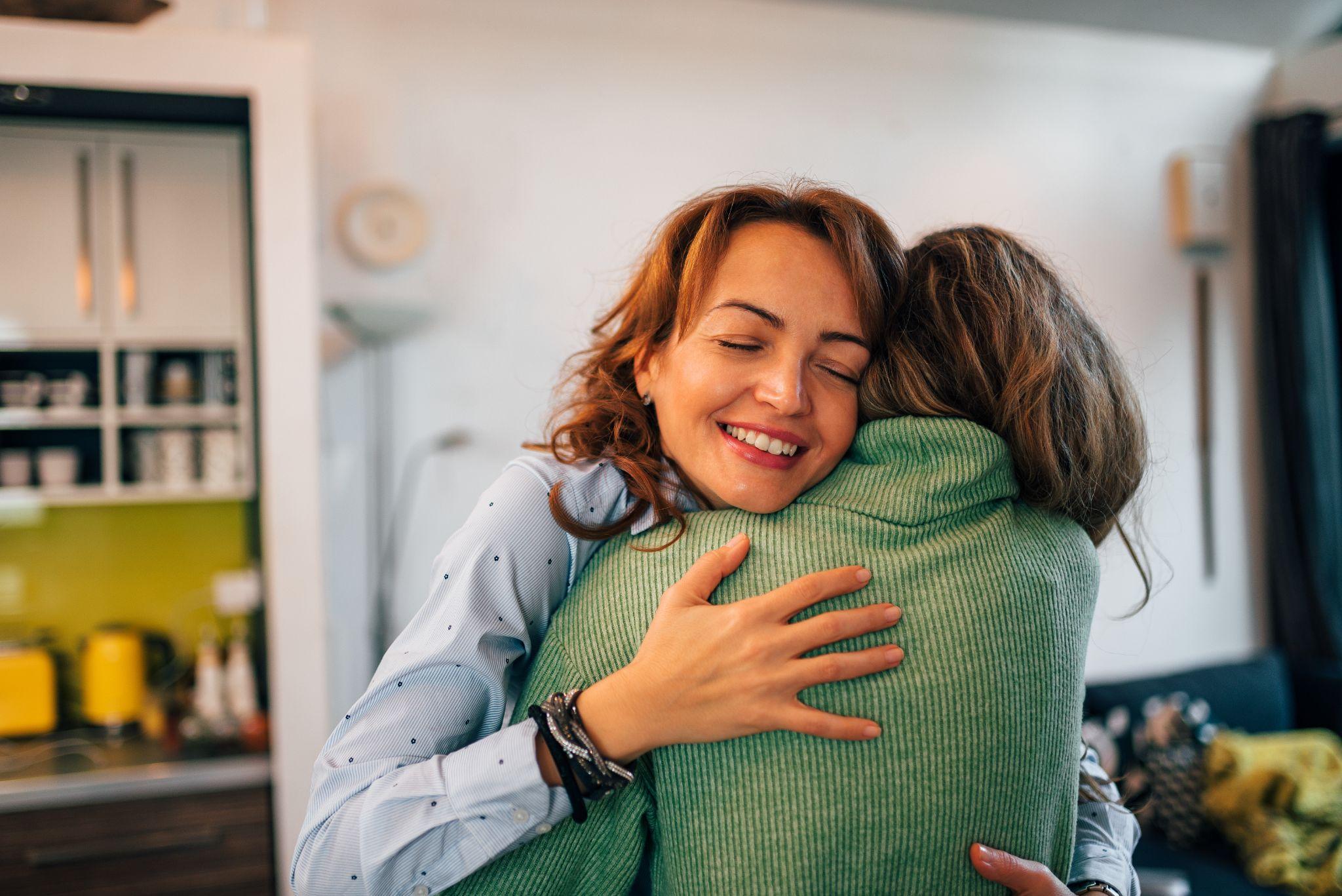 Family reunion. Mother and daughter embracing at home, portrait, close-up.