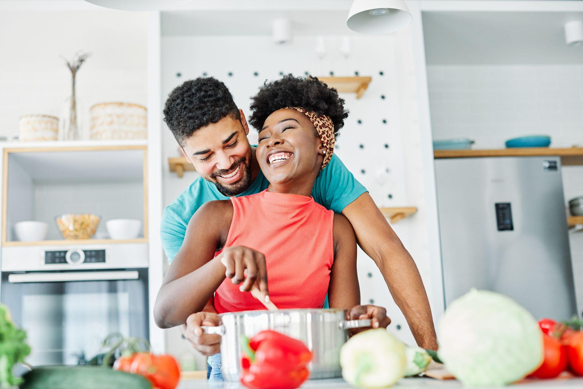 african american couple kitchen home cooking love happy together indoor food