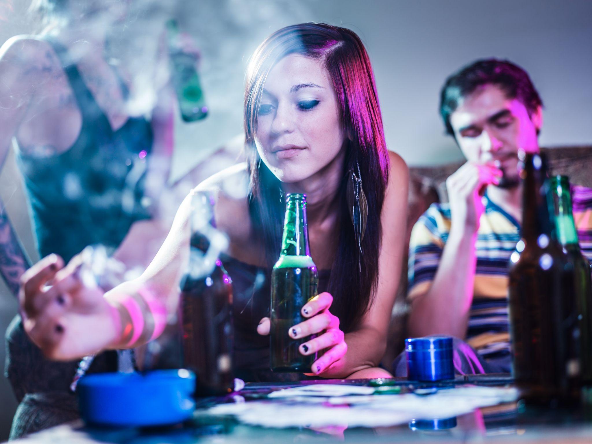 girl putting joint in ashtray at crazy party