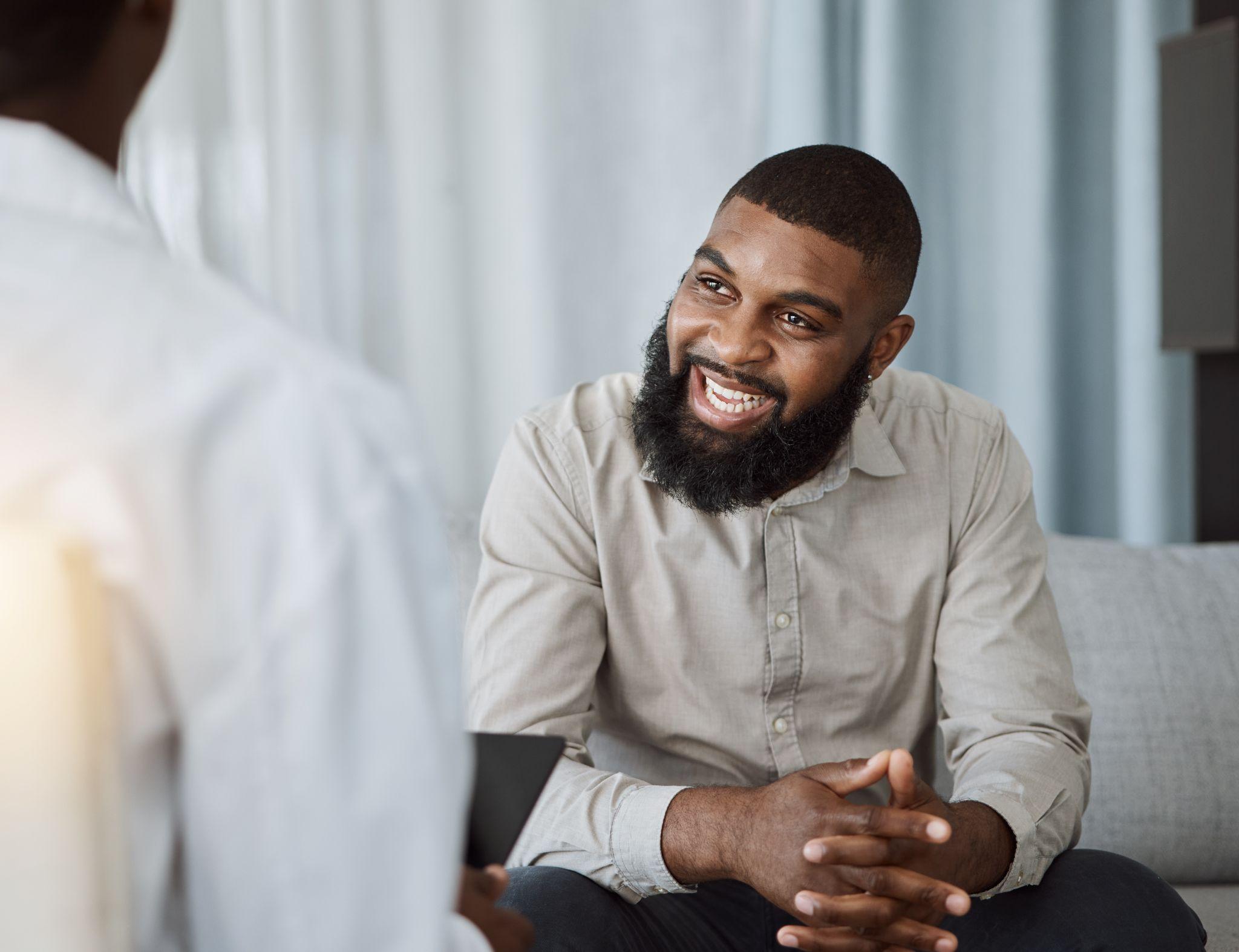 Happy black man, therapist and consultation in meeting for healthcare, mental health or therapy at the hospital.