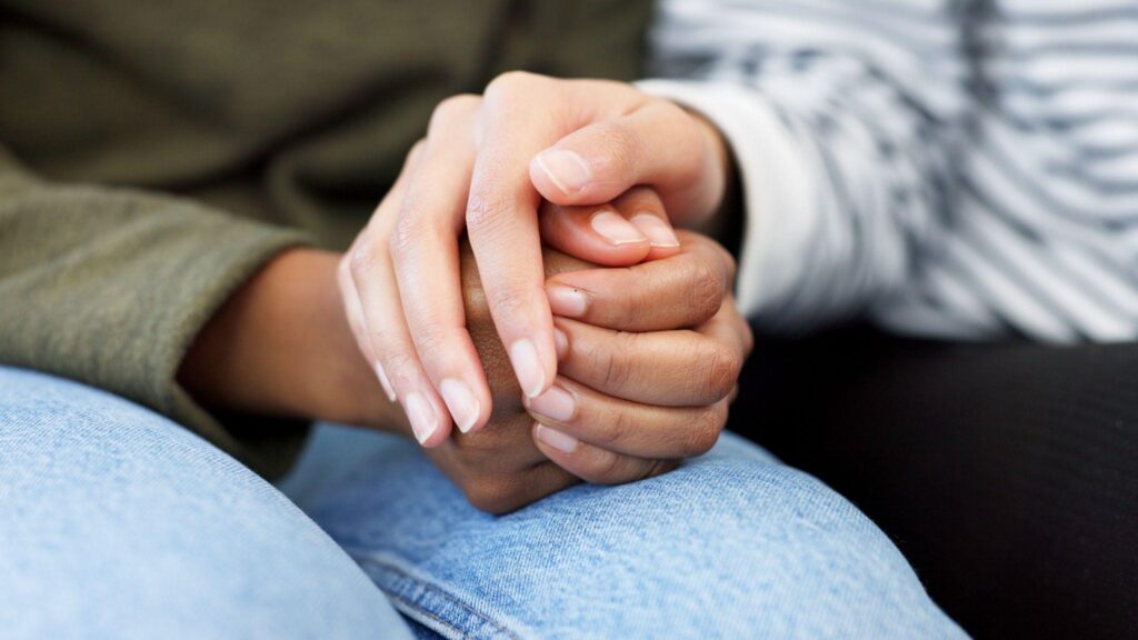 Holding hands, support and closeup of a couple in therapy for love