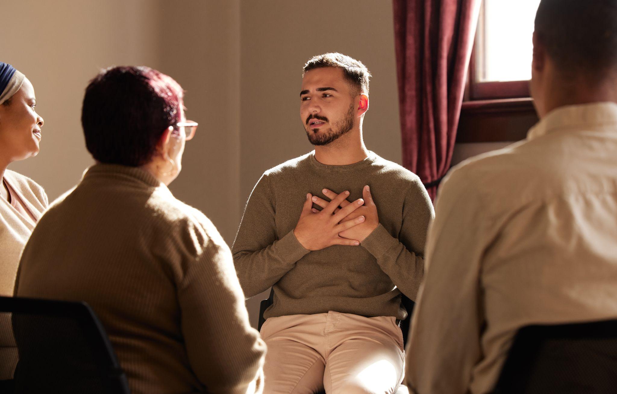 Mental health, addiction or depression, men and women with therapist sitting together for healing.