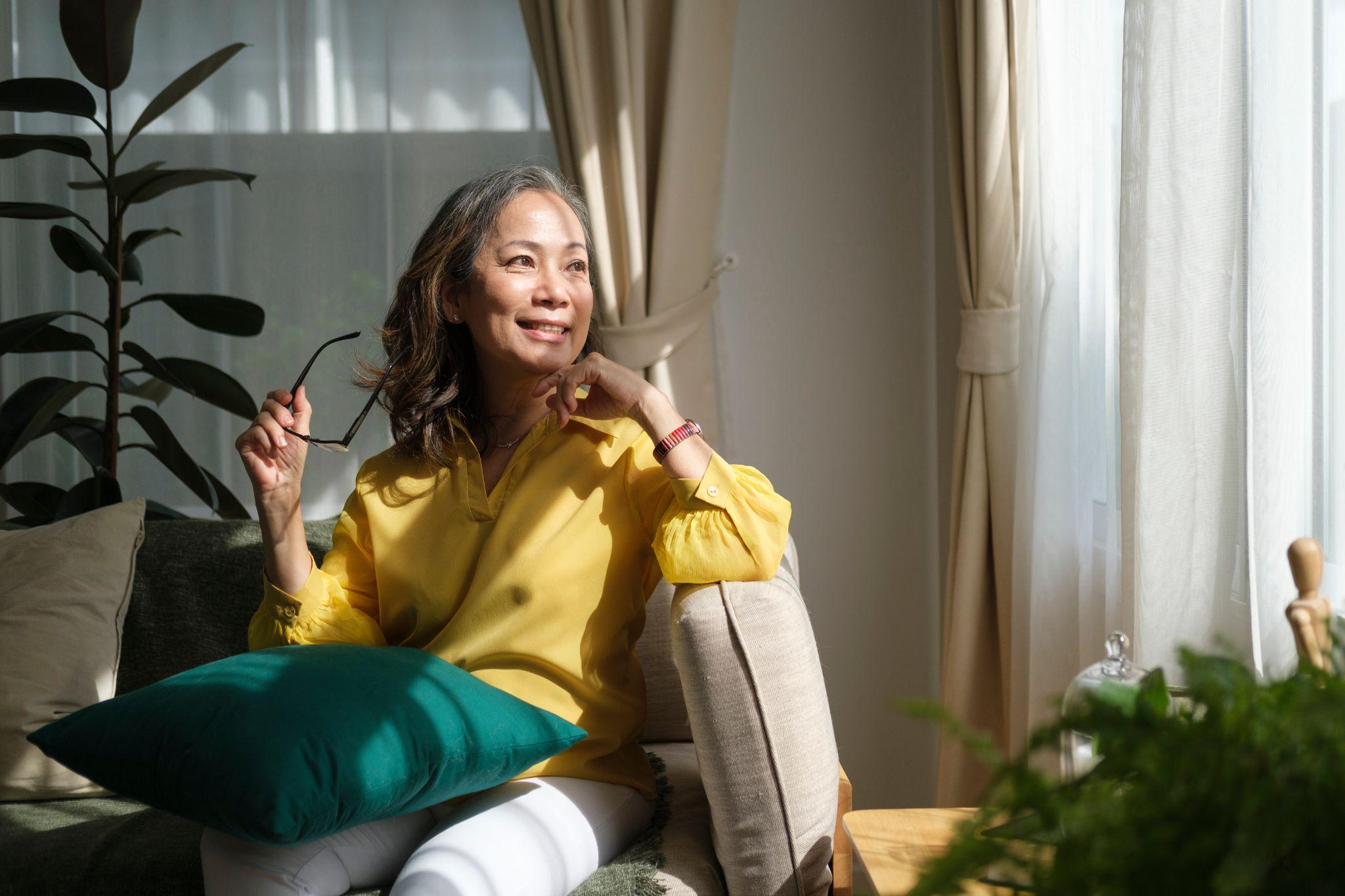 Middle aged woman resting on comfortable couch