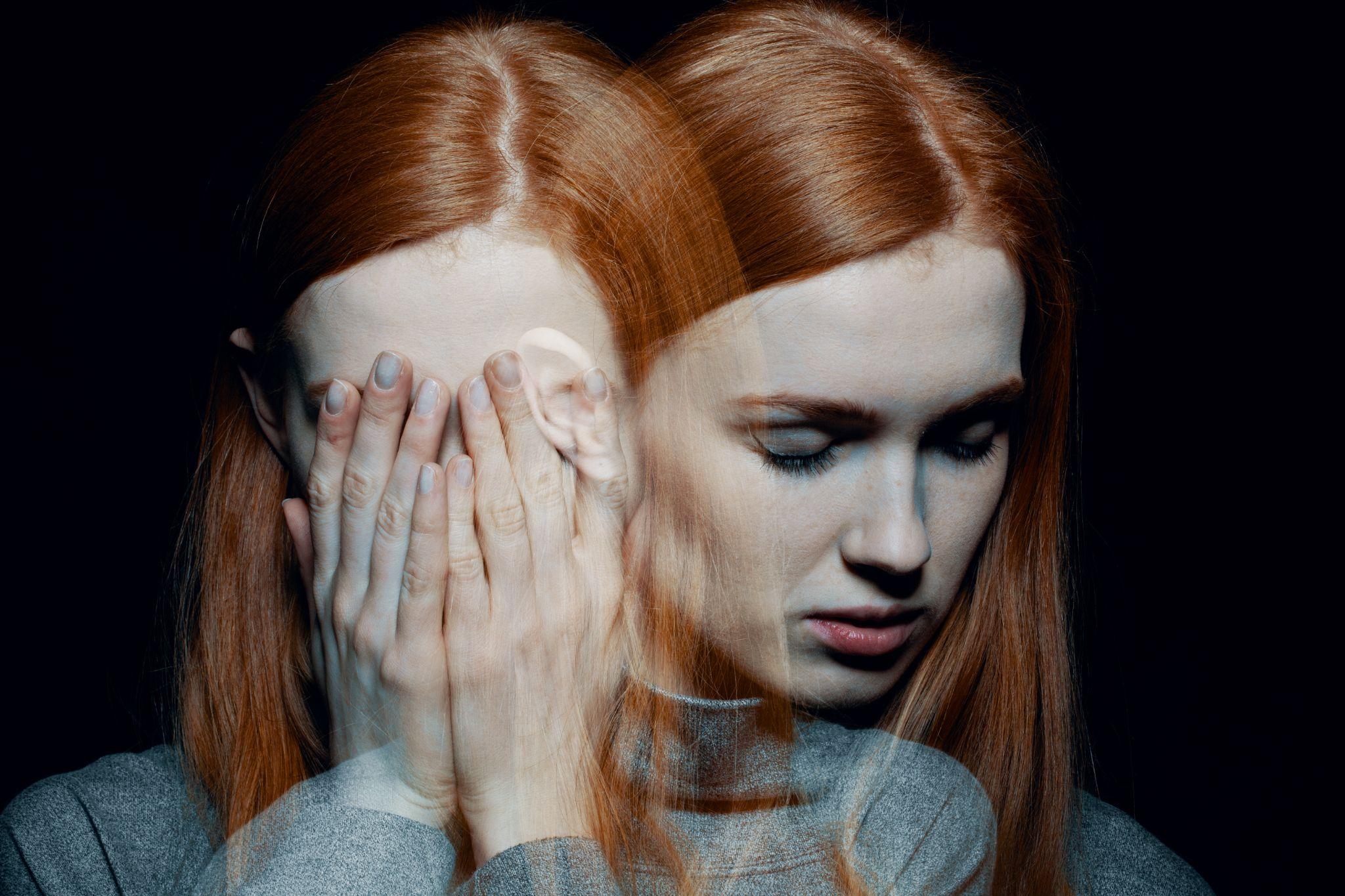 Porter of beautiful redhead girl with psychotic disorders covering her face
