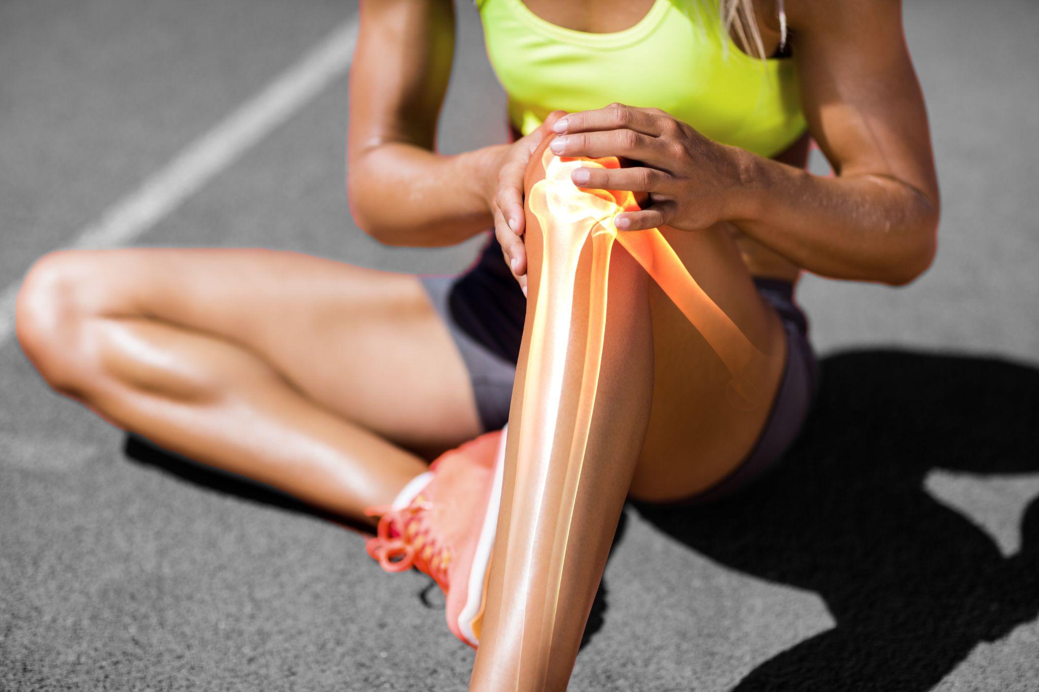 sportswoman suffering from knee pain