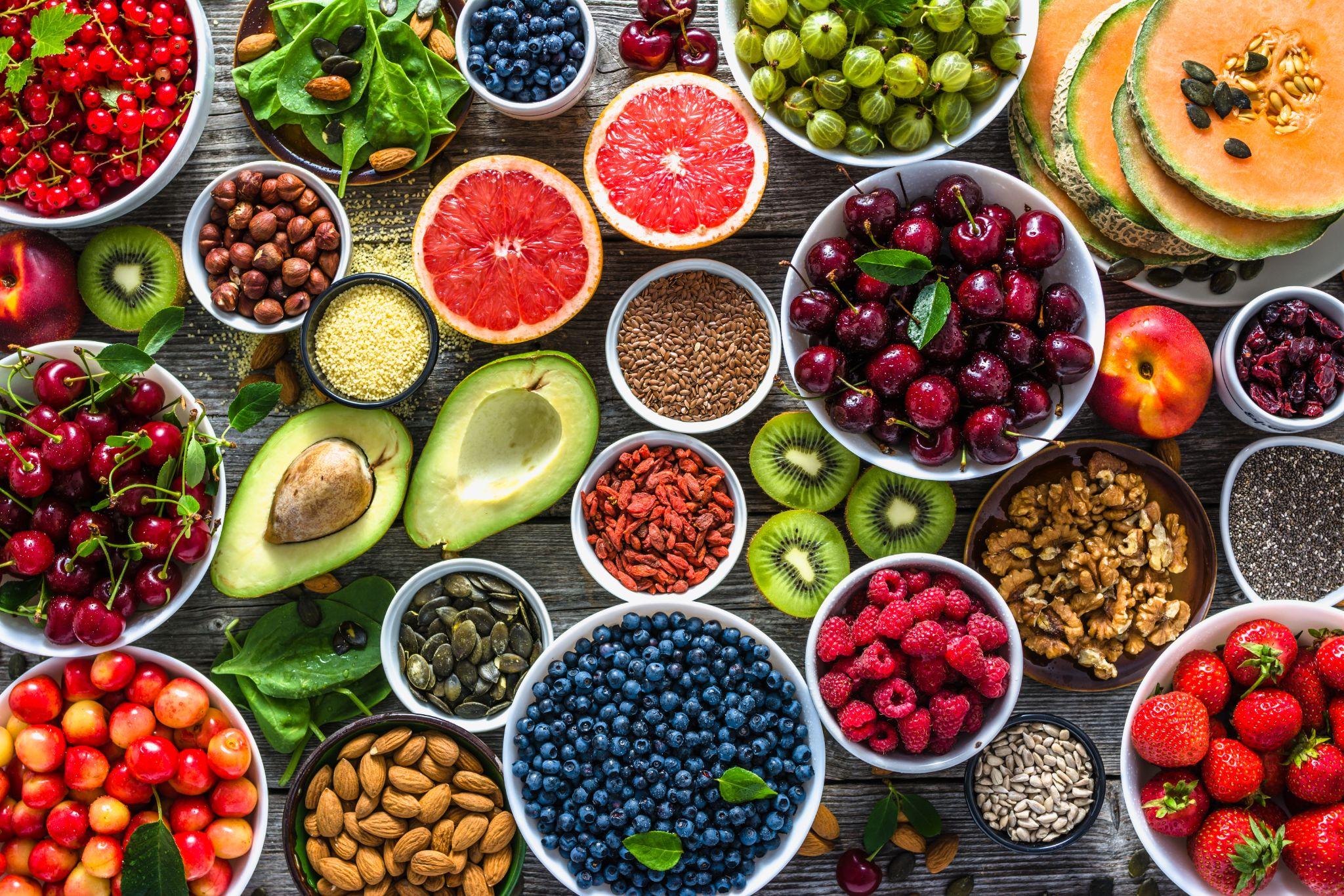 Superfoods, various fruits and assorted berries, nuts and seeds.