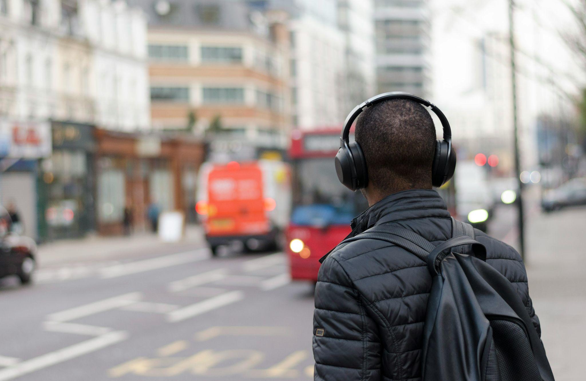 man in headphones walking in the street