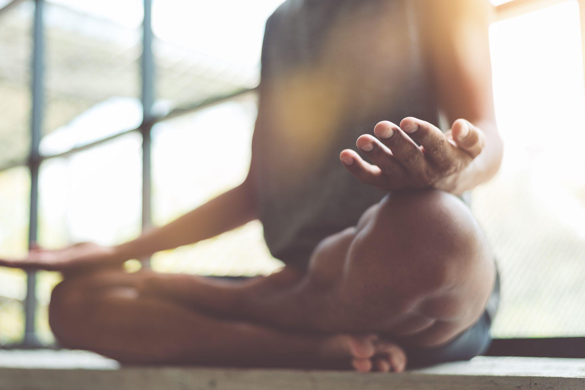 man practicing meditation indoors