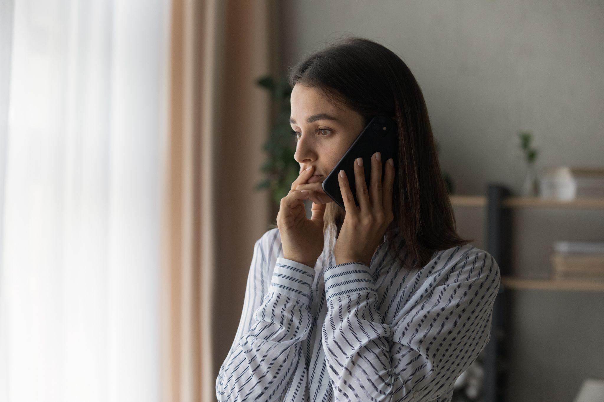 Sad woman has difficult phone talk