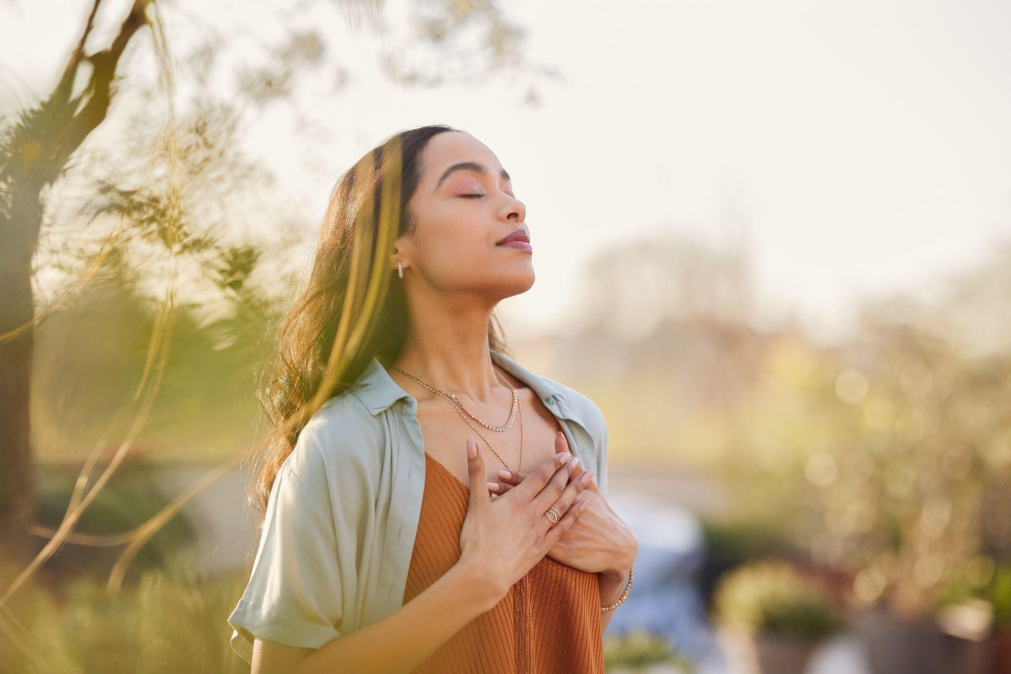 woman relax and breathing fresh air outdoor at sunset