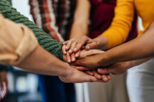 group session with hands joined at drug and alcohol treatment in San Dimas, CA